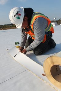 Curtis Construction worker laying a new roof